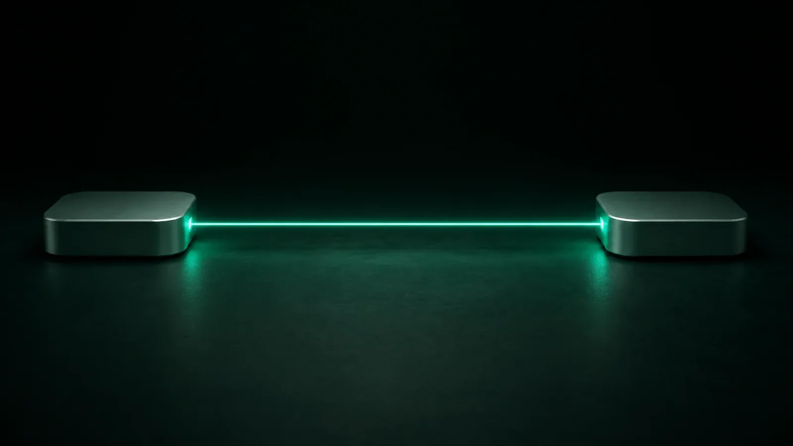 Two small aluminium boxes facing each other on a dark floor, joined by one straight beam of teal light.