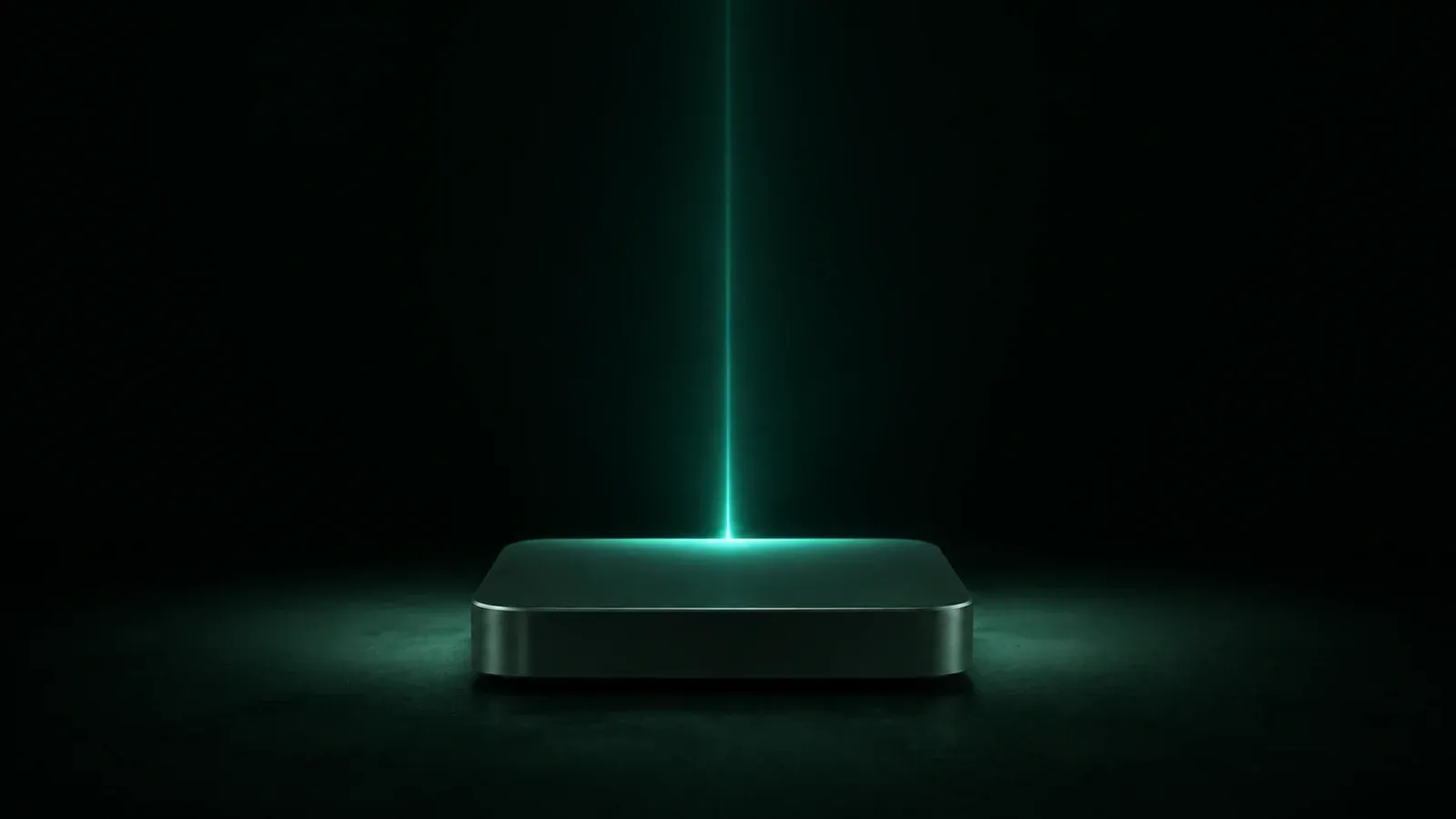 A small flat aluminium box on a dark surface, with a single thin beam of teal light rising from it.